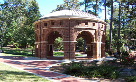 The rotunda stands in the shade of trees in President's Park.