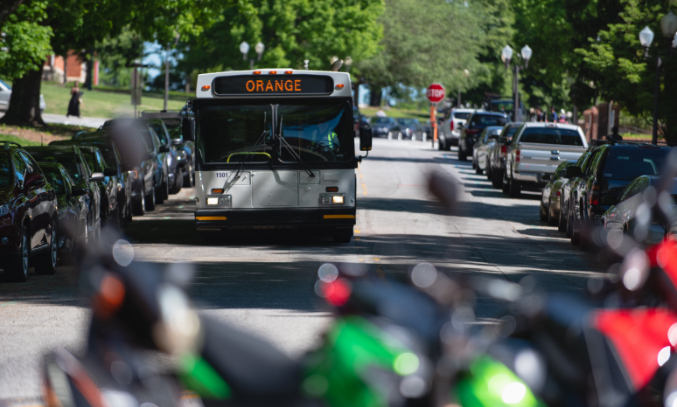 A Catbus drives down the street beside Hardin Hall.